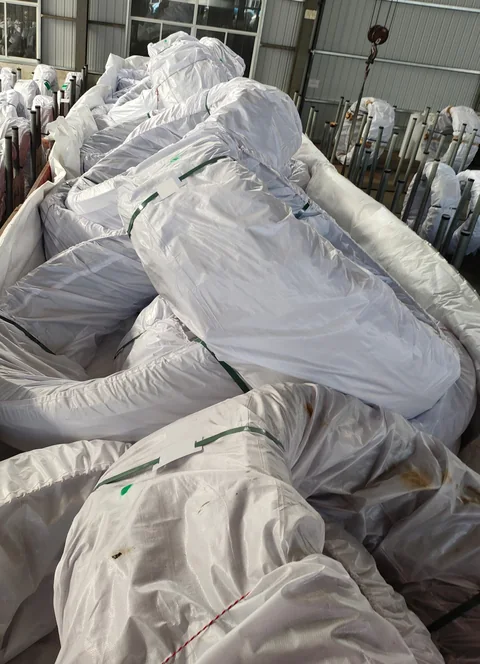 Loaded coils checked for packaging condition and package count before the tarpaulin is fitted.