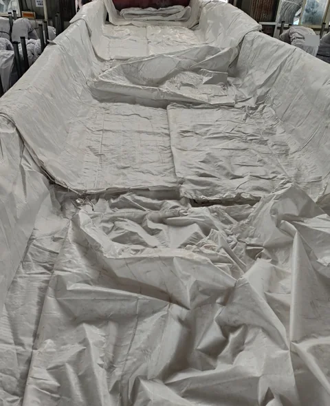 Protective liners fitted before loading to separate the cargo packaging from the truck bed.